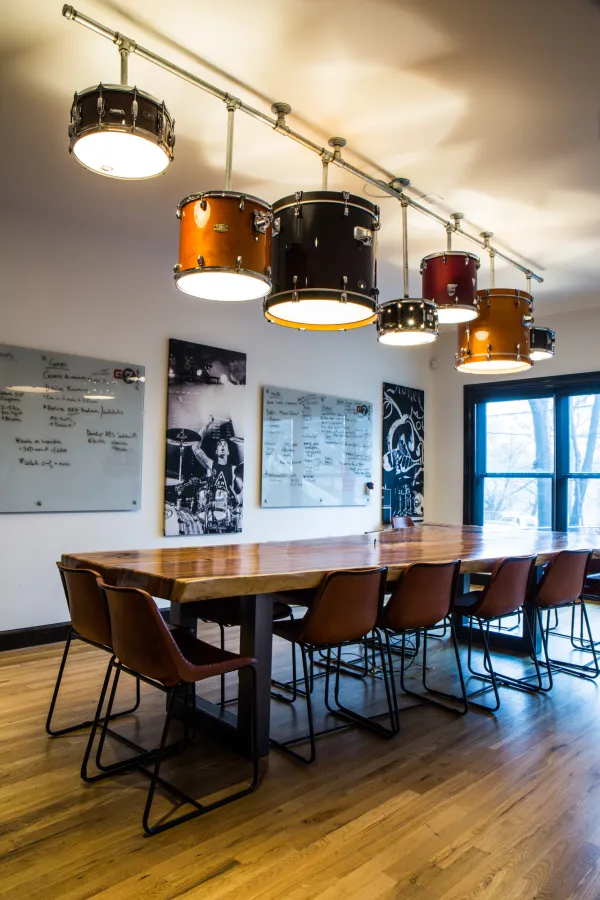 Image of a conference room consisting of a long table and lights with drum shades