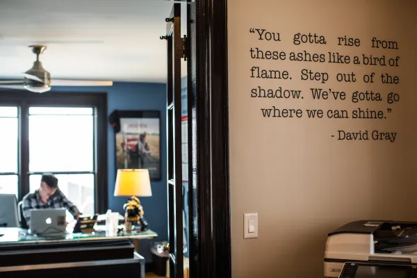 Image depicting an office with a quote on the exterior wall