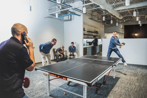 image of employees playing table tennis
